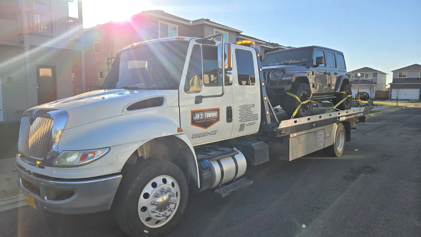 JD’s Towing flatbed carrying a Jeep in the Portland area